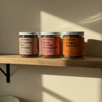 Three jars of tea from Iake & Oak on a wooden shelf