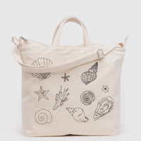 Beige Baggu duck bag with black seashell embroidery on a white background