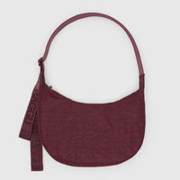 medium Baggu crescent bag in mahogany red against a light grey background