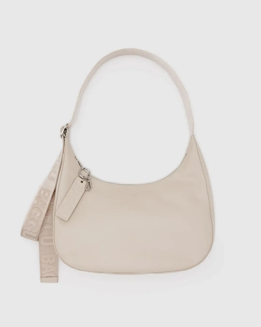Stone Baggu leather medium crescent bag with a matching strap on a white background