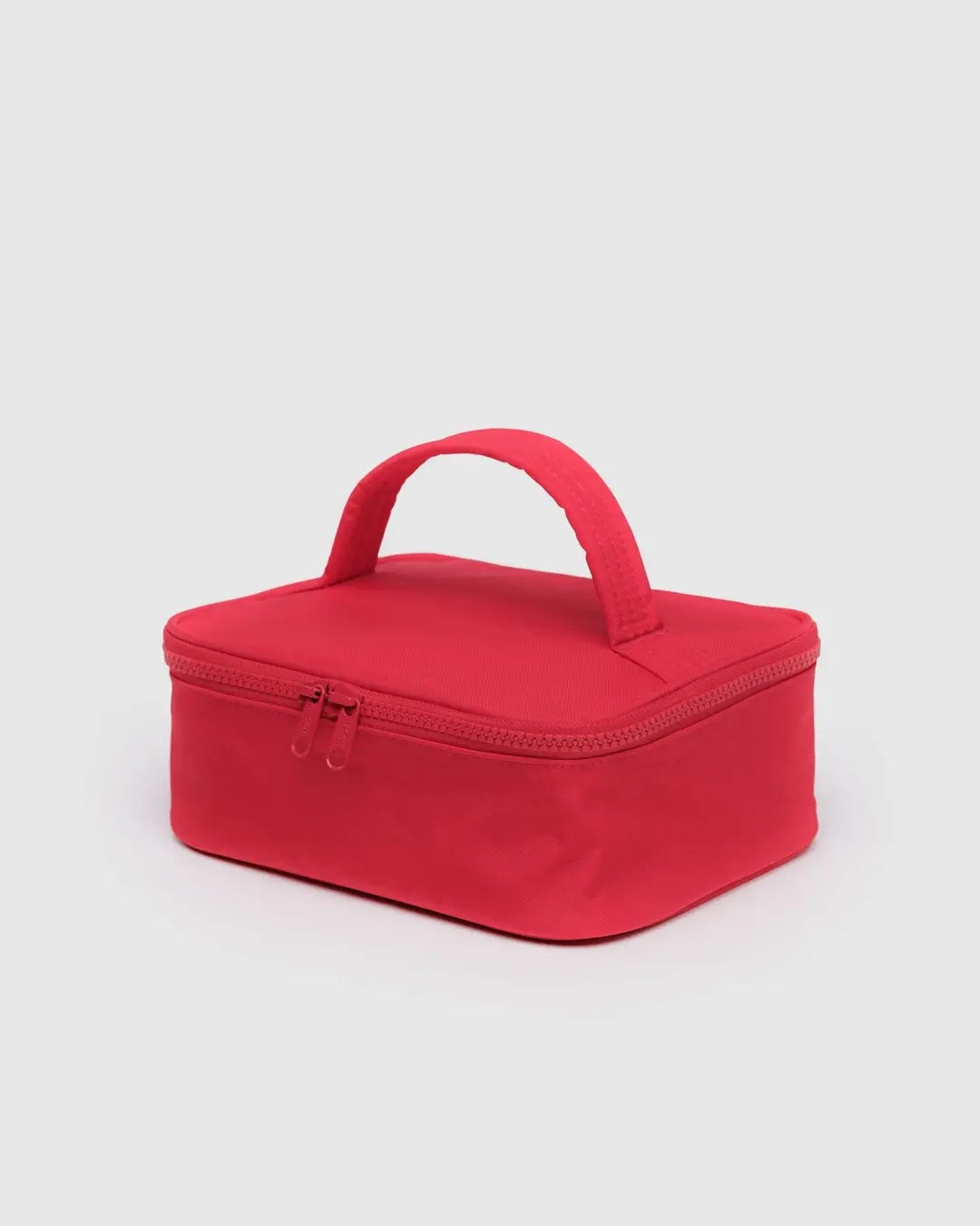 Red rectangular Baggu cosmetic  case with a handle on a light gray background