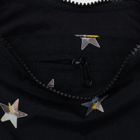Close up image of a Baggu small black crescent bag with silver star print. Stars appear as though they are sewn on sequins.