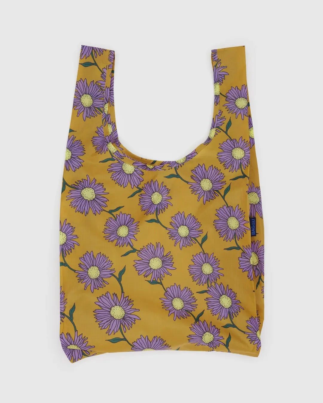Baggu standard reusable bag with purple floral pattern on mustard yellow background