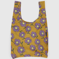 Baggu standard reusable bag with purple floral pattern on mustard yellow background