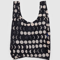 A Big Baggu reusable bag with a white moon pattern on black nylon background