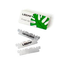 Packaging and single-edge razor blades with 'LEAF' branding and the slogan 'i am not plastic' on the blades.