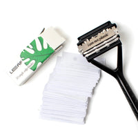 a pack of 50 Leaf Shave razor blades with a black triple blade razor on a white background