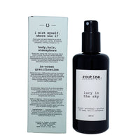Routine 'Lucy in the Sky' hair, body & atmosphere mist in a dark glass sprayer bottle with white label and outer box back view with ingredients list on a white background