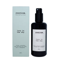 200 ml of Routine 'Lucy in the Sky' body, hair & atmosphere mist in a dark glass sprayer bottle with outer box packaging on a white background