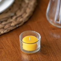 beeswax tea light in a glass cup on a table setting