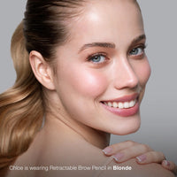 Woman with a smile, showcasing the use of a retractable brow pencil in blonde color.