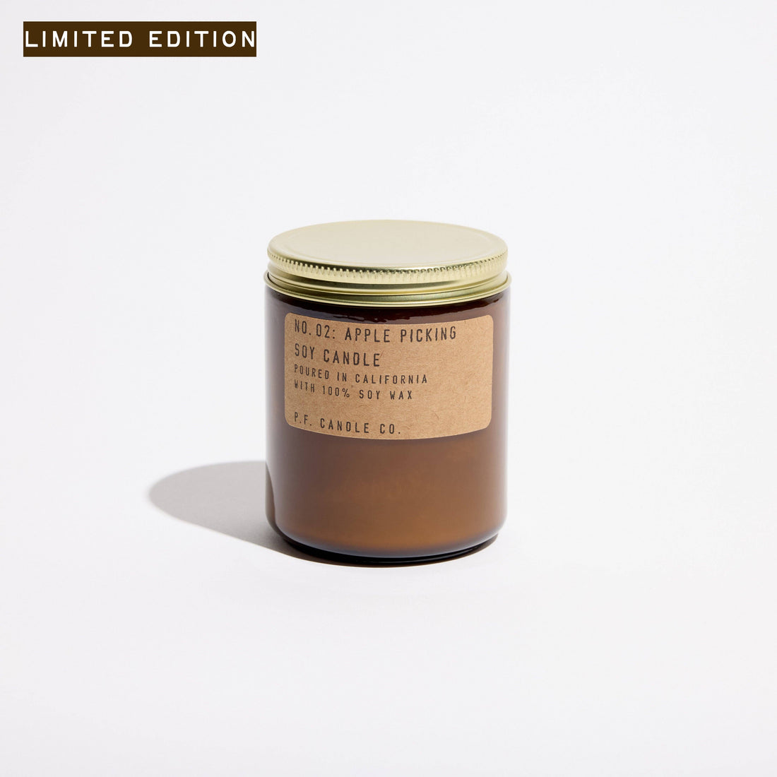 pf candle company soy candle in amber jar on a white background. the scent is apple picking