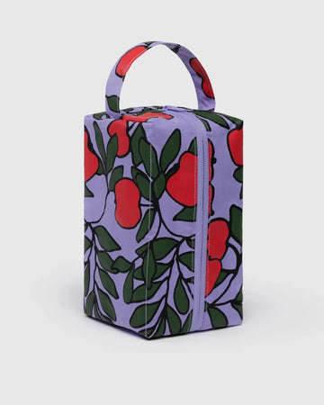 Rectangular Baggu Dopp Kit bag with red apple pattern on a purple background