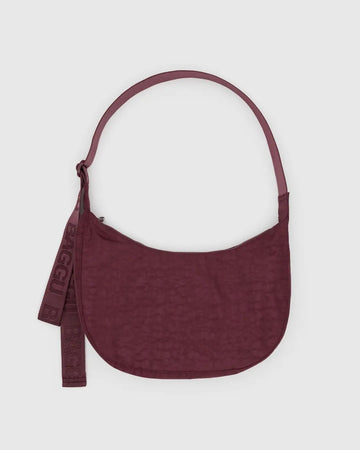 medium Baggu crescent bag in mahogany red against a light grey background