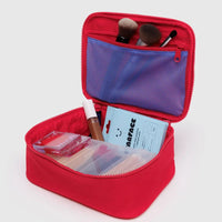 Red Baggu cosmetic bag with makeup items on a white background