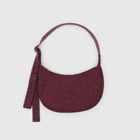 baggu small nylon crescent bag in mahogany red against a pale grey background
