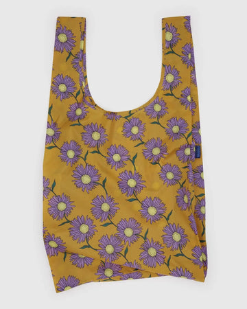 Reusable Big Baggu bag with purple floral pattern on a mustard yellow background