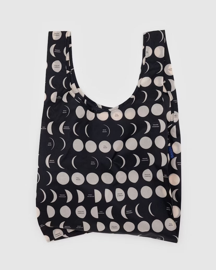 A Big Baggu reusable bag with a white moon pattern on black nylon background
