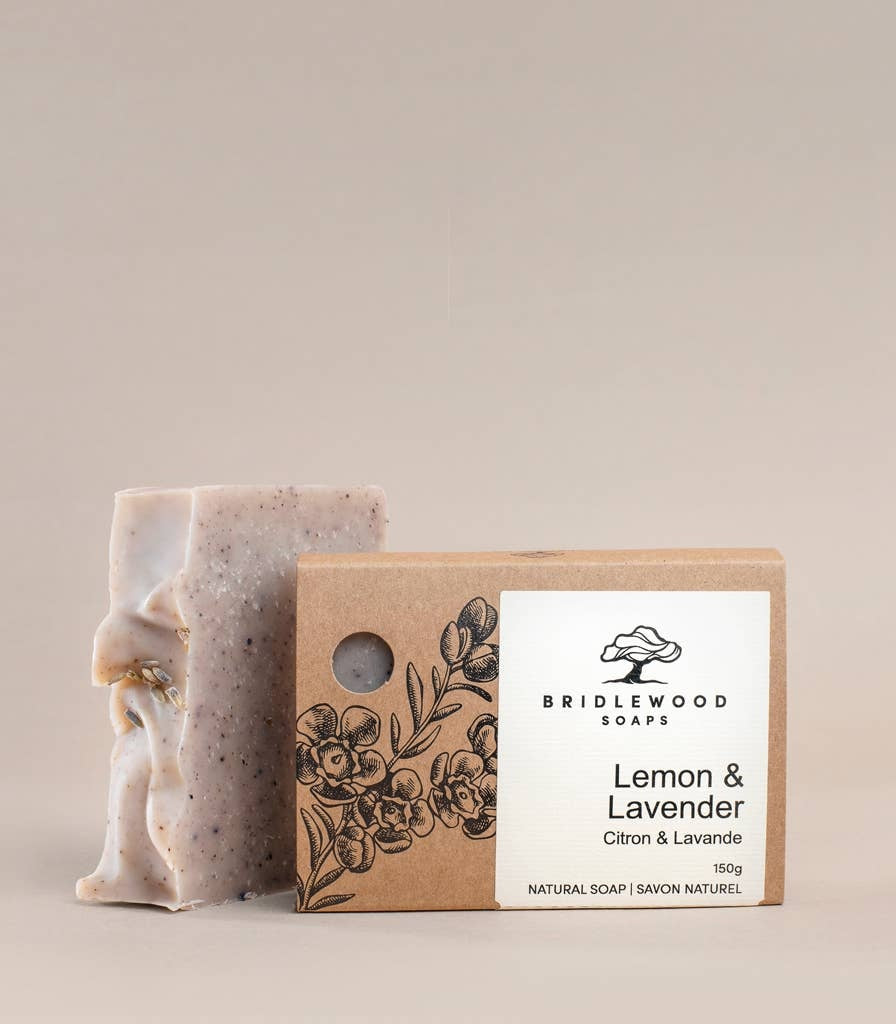 Bar of soap with a cardboard box labeled 'Bridlewood Natural Soaps Lemon & Lavender' on a beige background