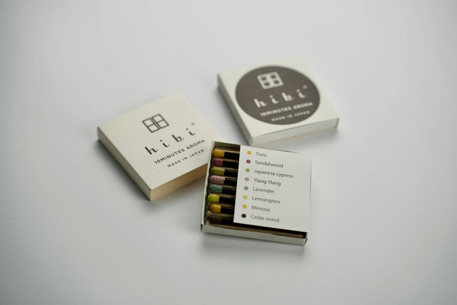 Matchbox containing 8 different hibi 10 minute aroma incense matches with 'hibi' branding on a light gray background