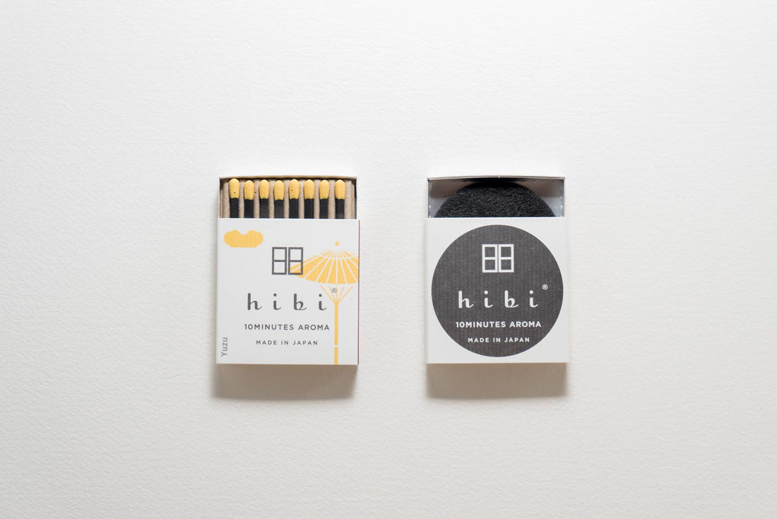 Two packages of hibi yuzu scented incense match sticks on a white background