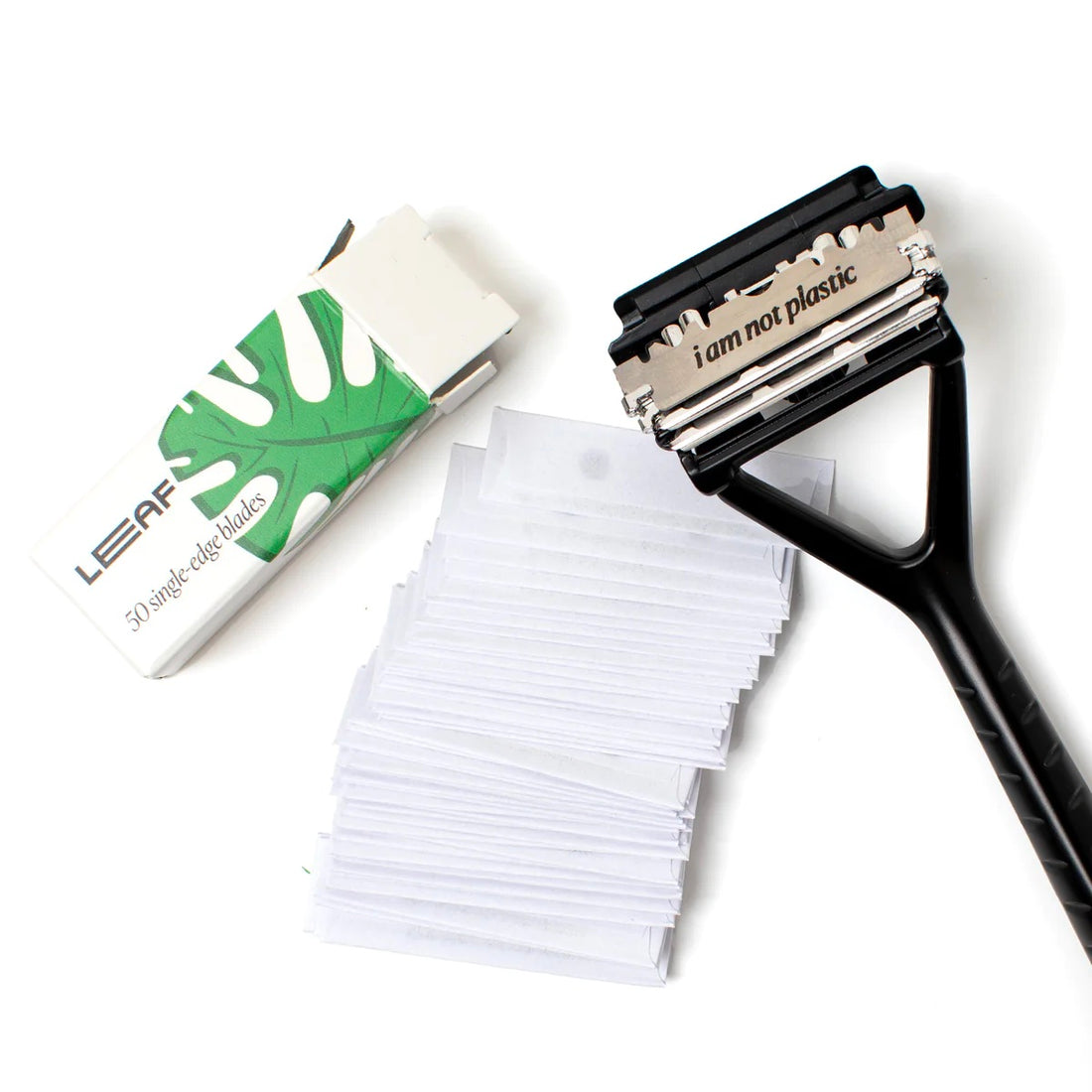 a pack of 50 Leaf Shave razor blades with a black triple blade razor on a white background