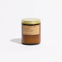 p.f. candle goldcoast scented candle with a gold lid and label on a white background