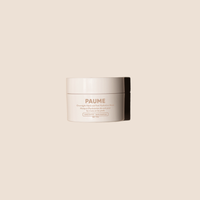 Jar of cream with 'PAUME' branding on a beige background