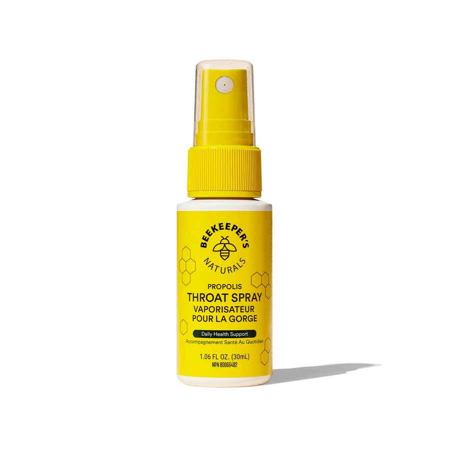 A yellow spray bottle labeled 'Beekeepers Naturals Propolis Throat Spray' designed for oral use.