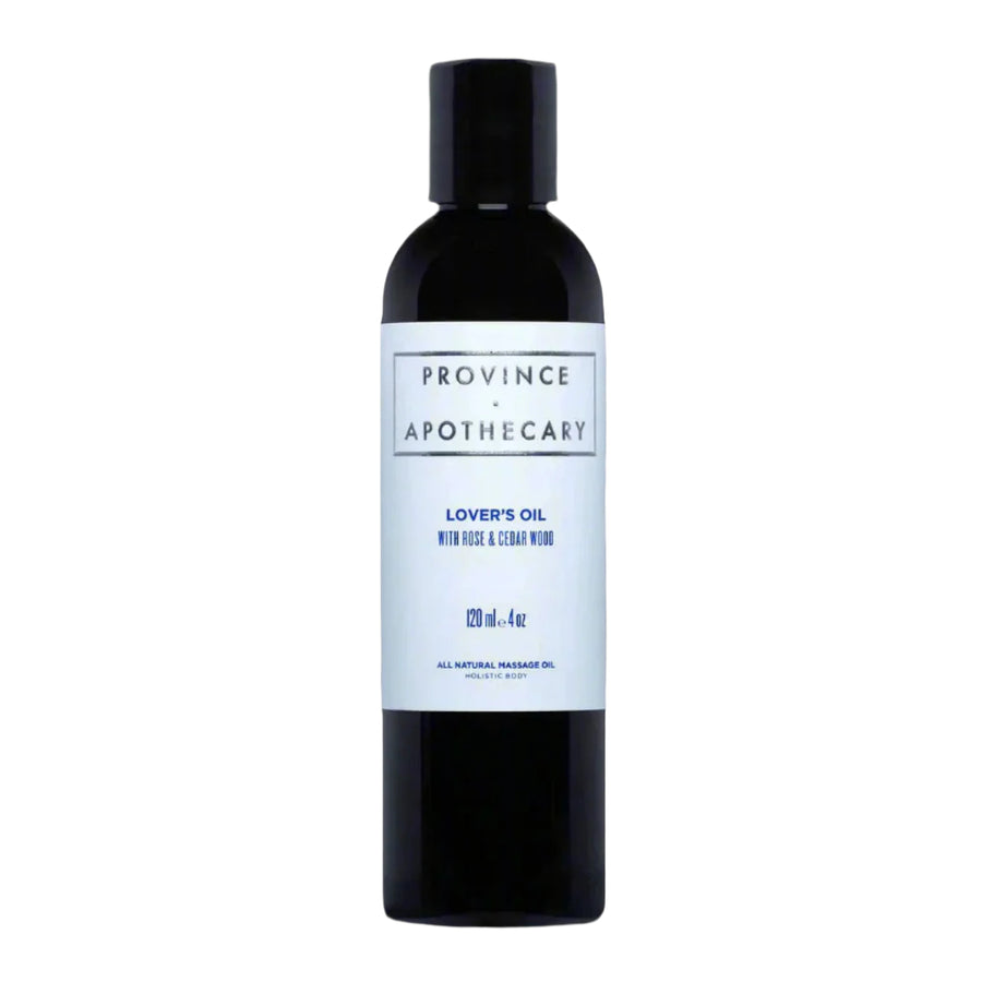 a dark bottle with pale blue label that says "Province Apothecary Lover's Oil with Rose & Cedar wood". The bottle is filled with the clear liquid massage oil blend.