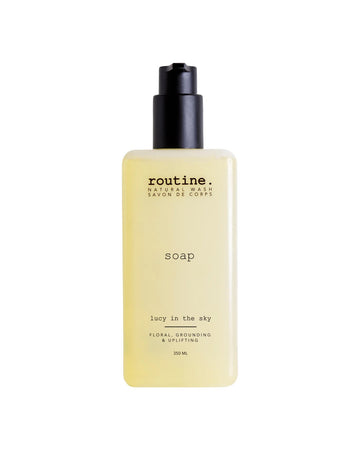 A bottle of Routine Lucy in the Sky natural hand and body wash on a white background.
