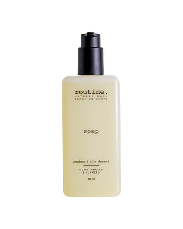 A bottle of Routine Reuben & The Desert natural hand and body wash on a white background