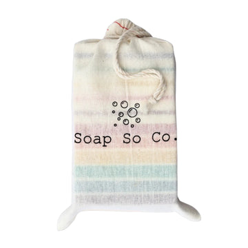 A Soap So Co branded cotton bag with a variety of their colourful soaps against a white background