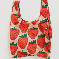 Baggu nylon reusable standard bag with large strawberry print on pink background
