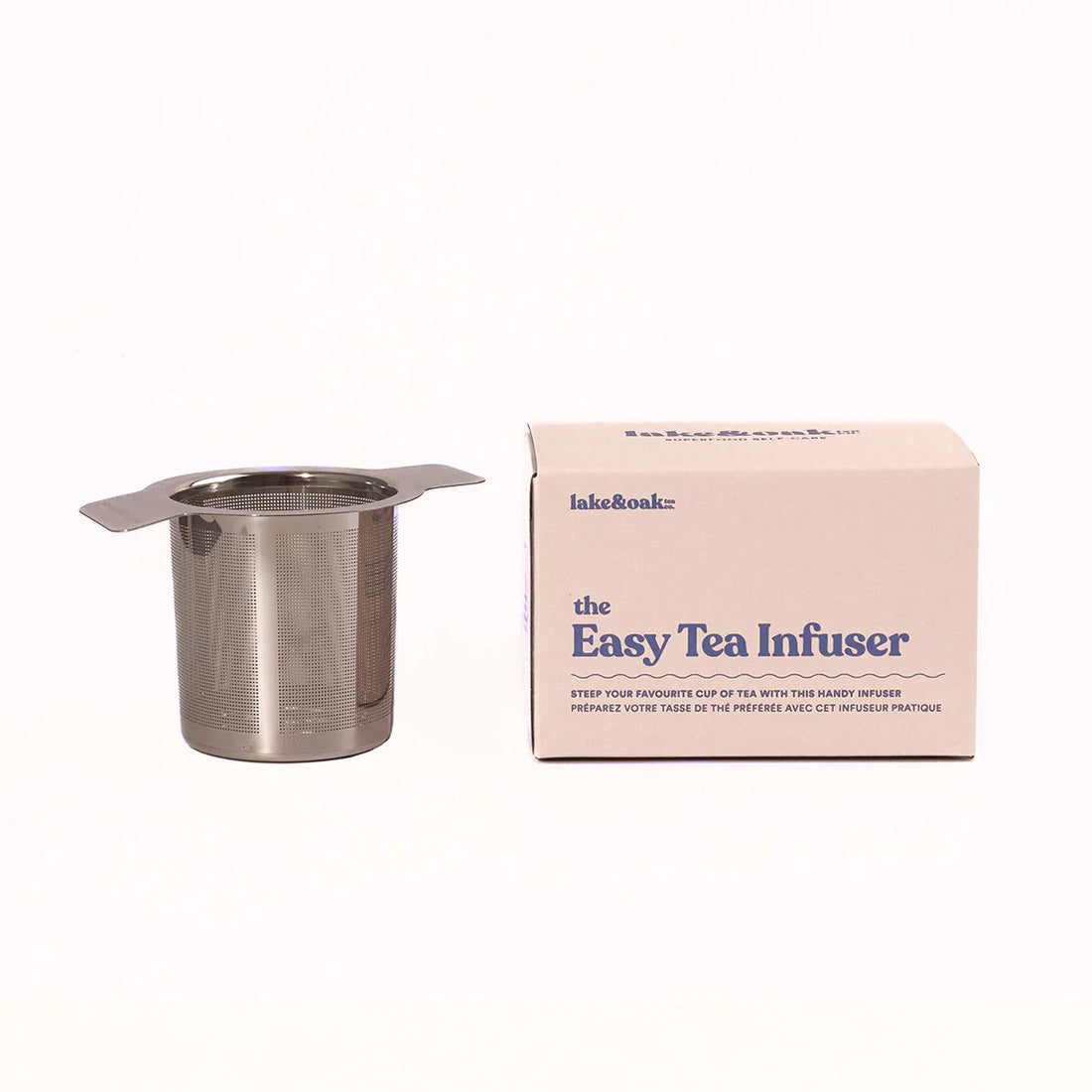 Metal tea infuser with packaging on a white background