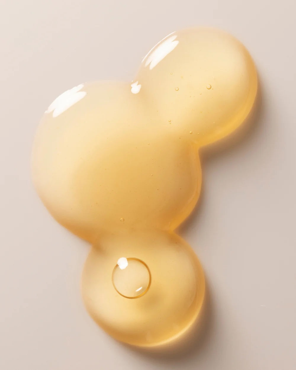 a close up texture image of Three Ships Jelly Drops showing the pale yellow colour and clear, viscous, jelly-like texture