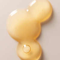 a close up texture image of Three Ships Jelly Drops showing the pale yellow colour and clear, viscous, jelly-like texture