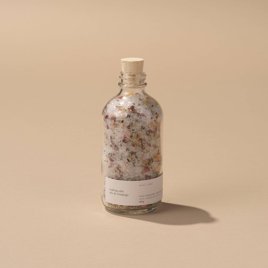 a bottle of well kept soaking salts on a beige background