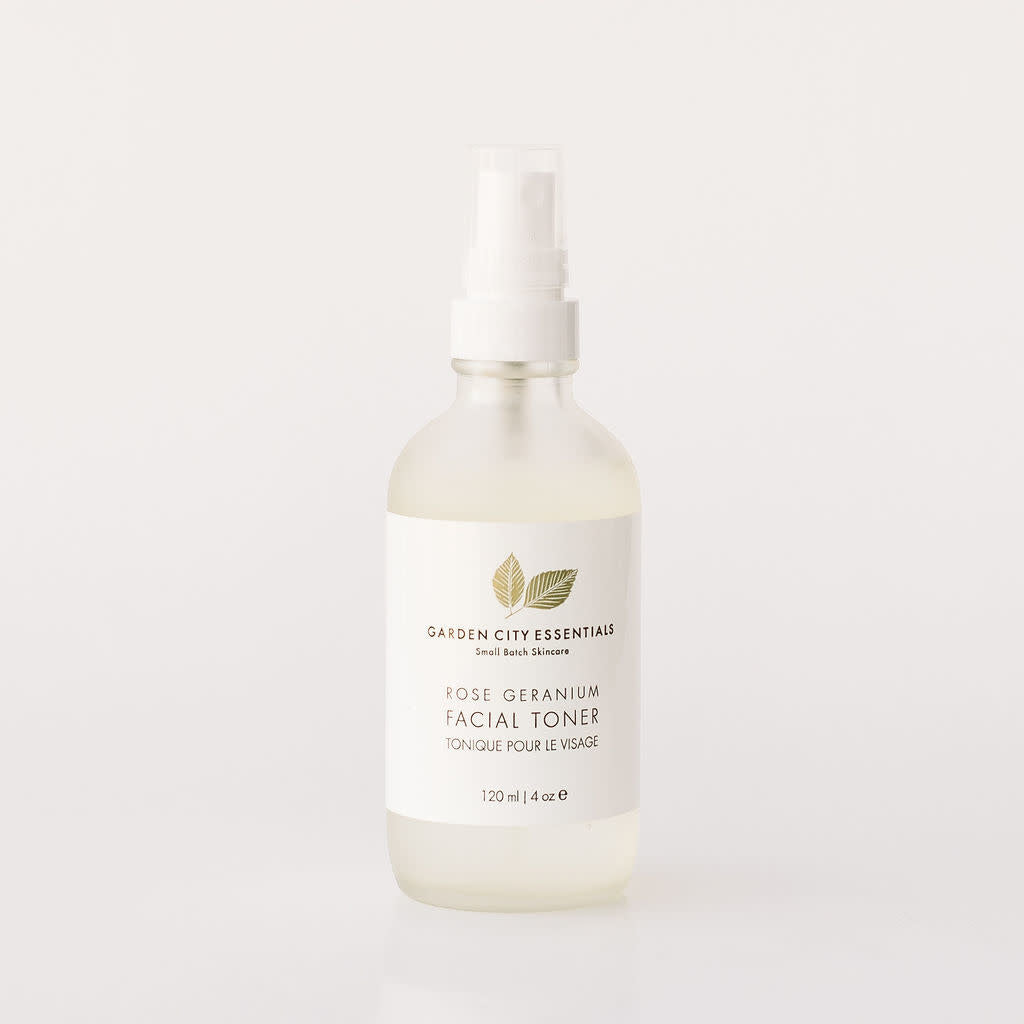A white spray bottle containing Garden City Essentials Rose Geranium Facial Toner, designed for use as a refreshing facial mist.