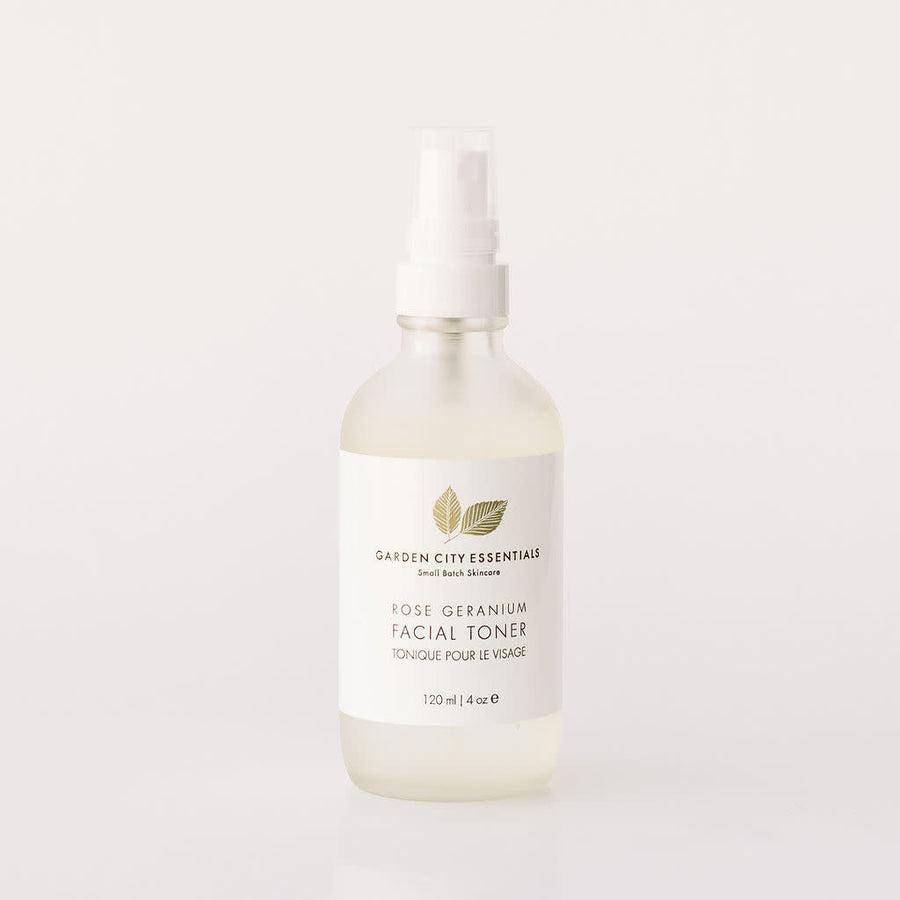 A white spray bottle containing Garden City Essentials Rose Geranium Facial Toner, designed for use as a refreshing facial mist.