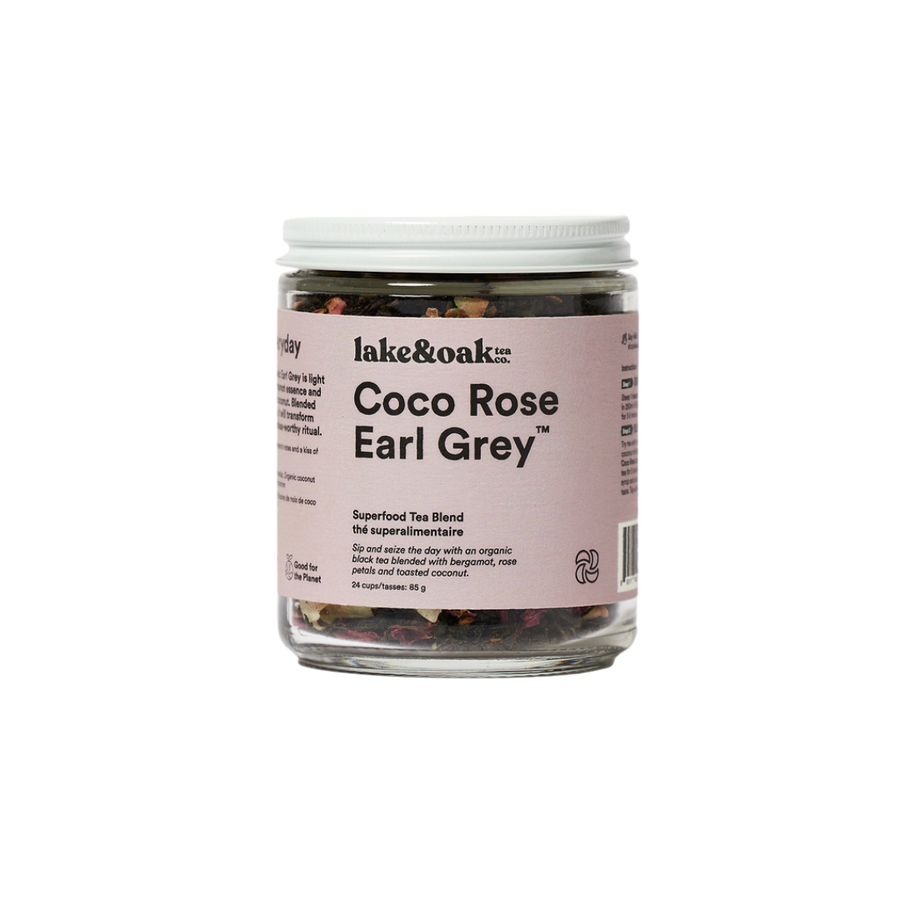 A jar of Coco Rose Earl Grey superfood tea blend by lake&oak. The jar is labeled with the product name and contains visible pieces of rose petals, coconut flakes, and other tea leaves.