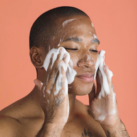 a person cleansing their face with Consonant Foaming Face Wash